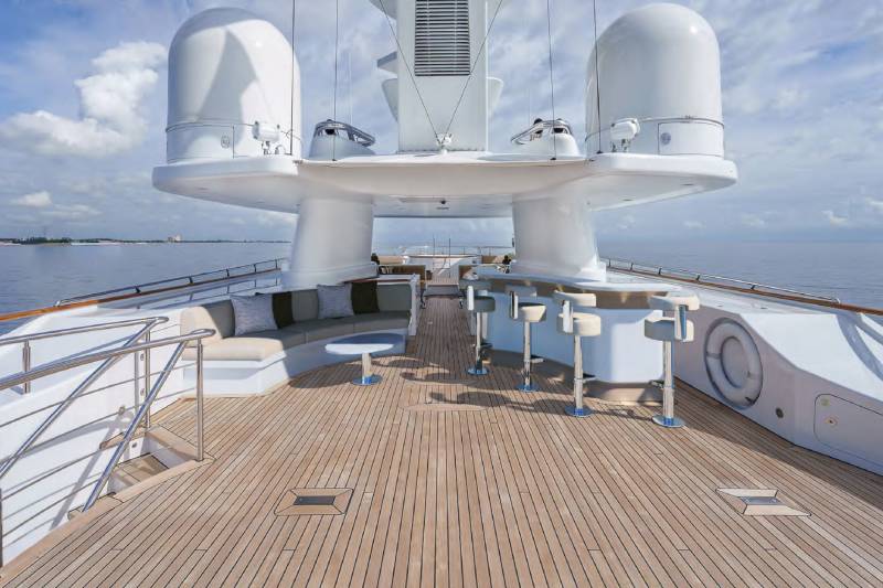 Luxurious yacht deck seating and bar area offers a perfect spot for enjoying the ocean breeze and stunning views.