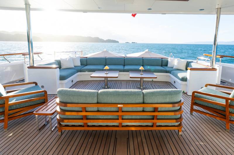 Relax in luxurious comfort on the spacious deck of this yacht, surrounded by the serene beauty of the ocean.