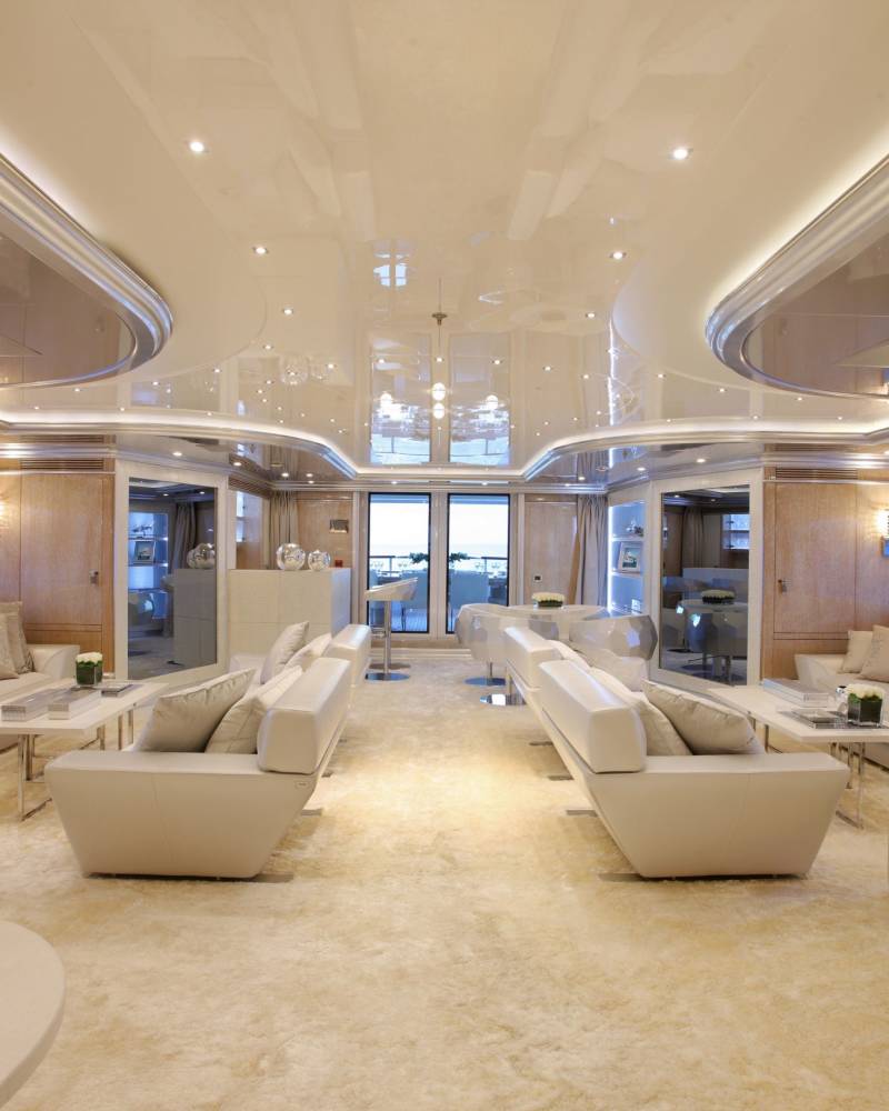 Luxurious yacht interiors offer plush seating and panoramic ocean views for ultimate relaxation.