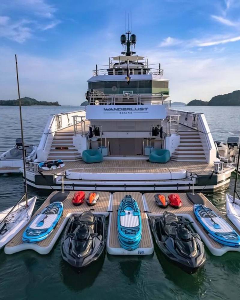 A luxurious yacht named Wanderlust Bikini is fully equipped with a fleet of jet skis and paddleboards for aquatic adventures.
