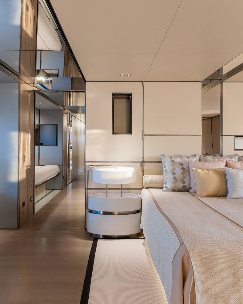 Luxurious yacht bedroom offers serene comfort with elegant furnishings and stunning ocean views.