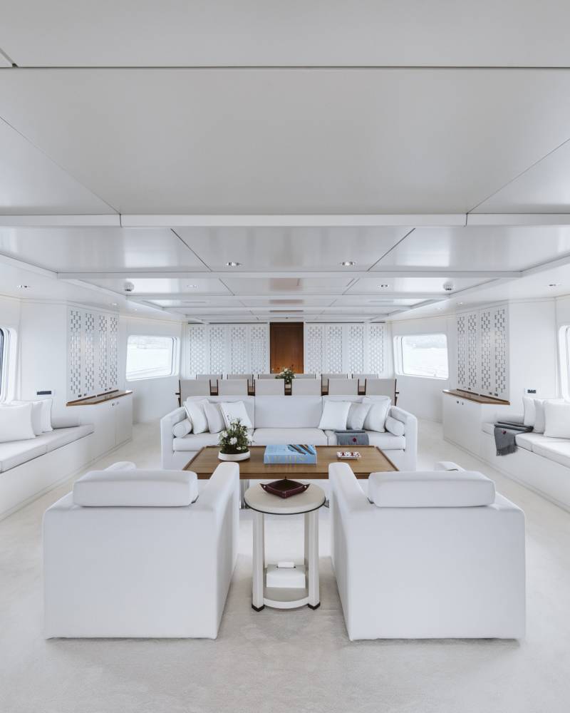 Luxurious white sofas and seating create a serene and spacious lounge aboard this elegant yacht.