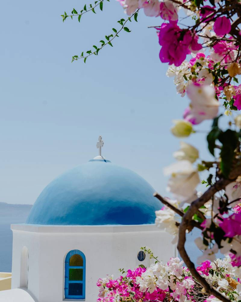 A large luxury yacht cruises through the crystal-clear turquoise waters of a tropical paradise, surrounded by lush, rugged cliffs and a pristine sandy beach.