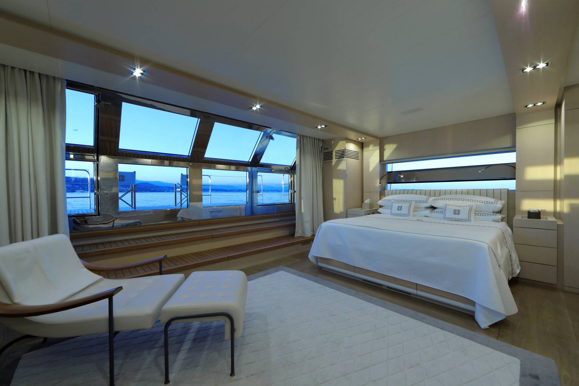 Experience unparalleled luxury in this serene yacht bedroom with breathtaking ocean views.