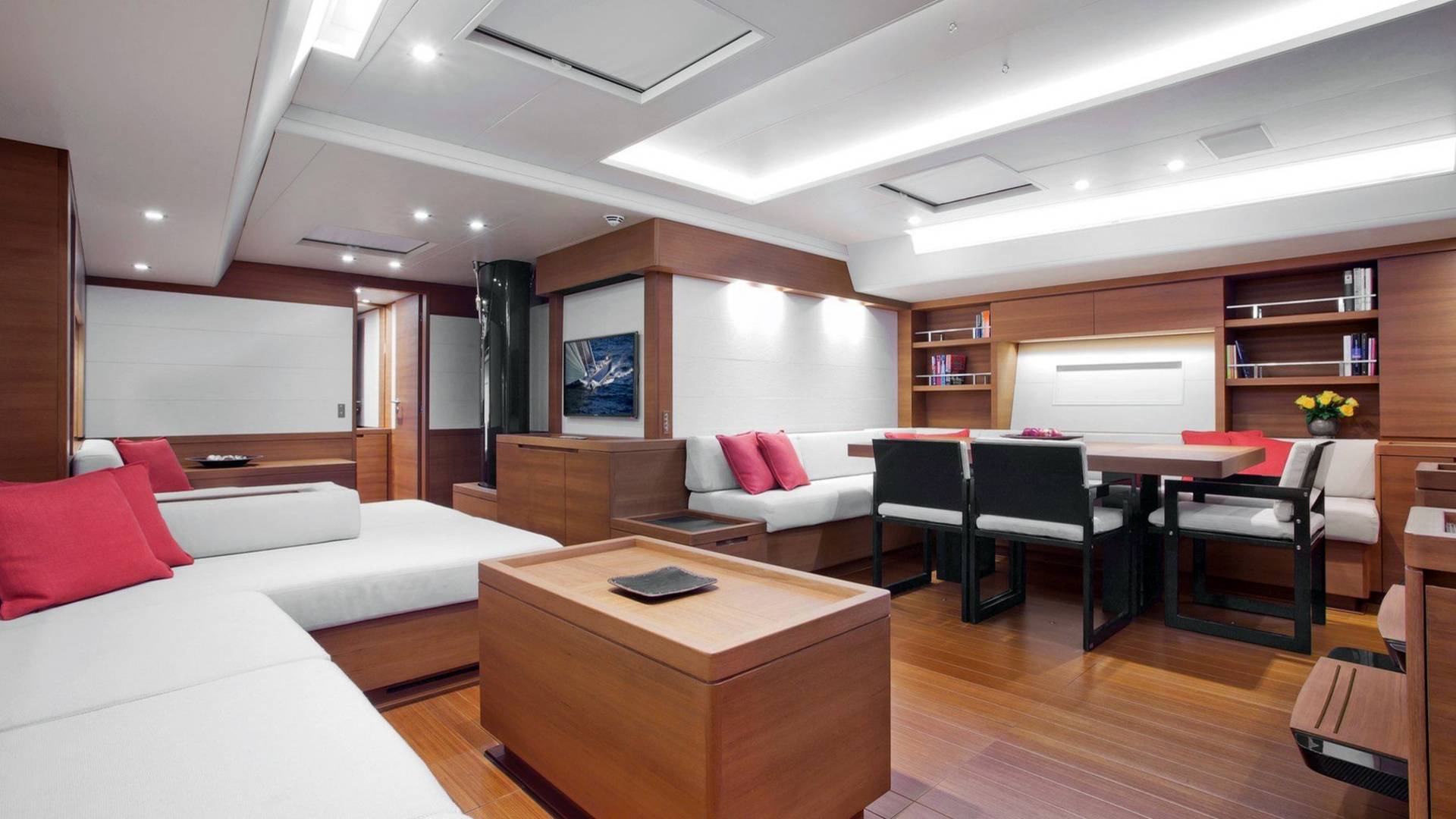 Luxurious yacht interiors feature plush white seating, rich wood accents, and a modern dining area perfect for entertaining at sea.