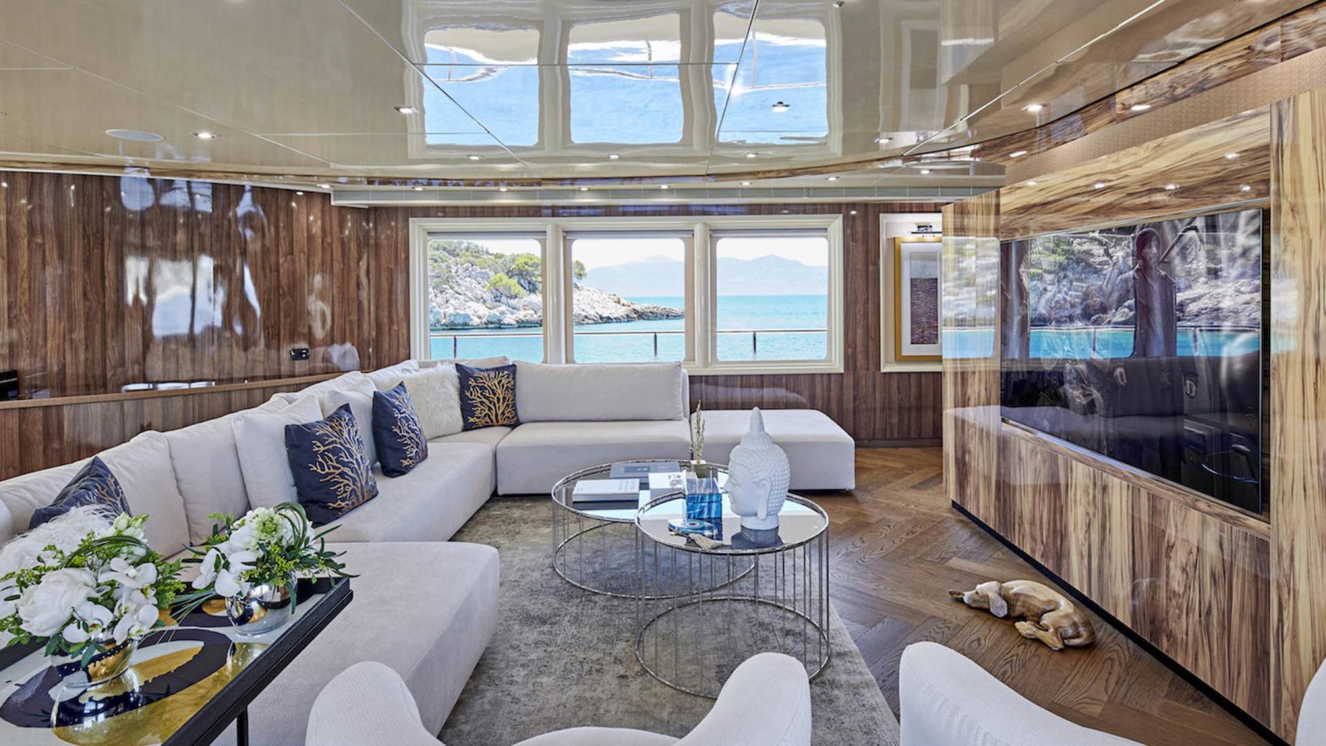 Luxurious yacht interiors blend natural wood finishes with expansive windows offering breathtaking ocean views.