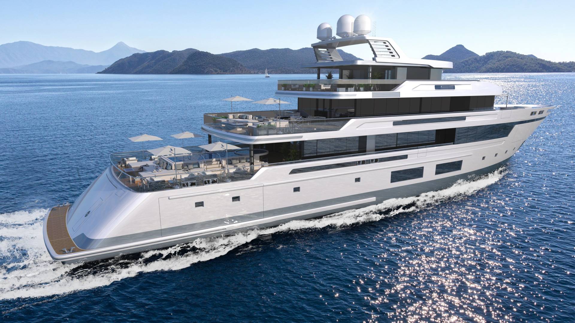 A sleek, modern yacht cruises through sparkling blue waters with a mountainous coastline in the background.