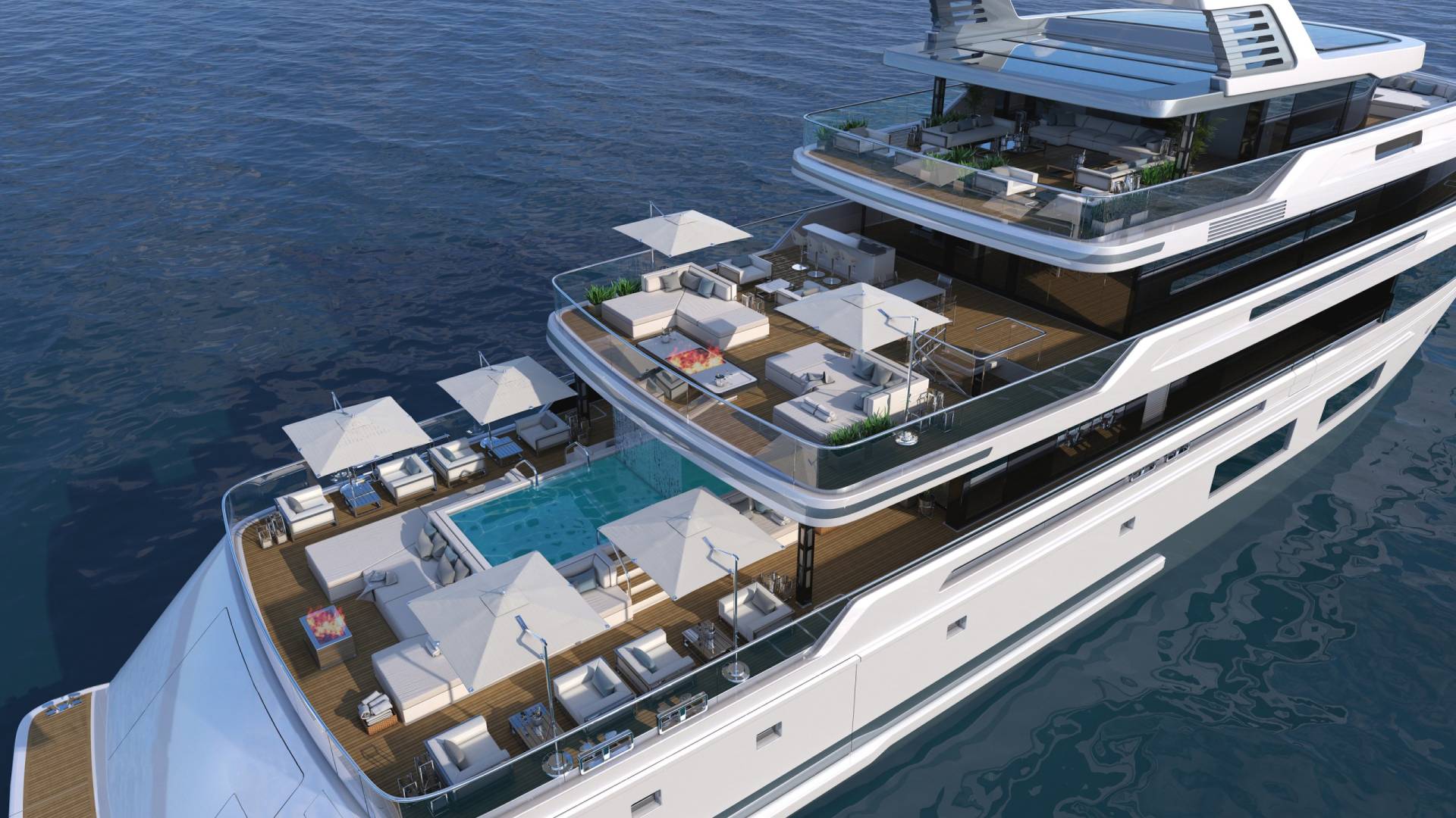 This luxurious yacht offers multiple levels of outdoor living space, complete with a pool, lounge areas, and a fire pit.