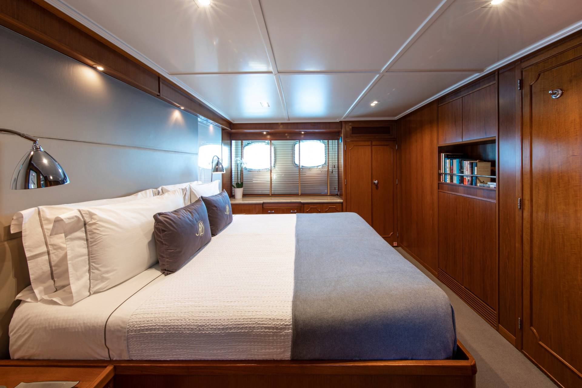 Luxurious wood paneling and plush bedding create a serene sanctuary aboard this elegant yacht.