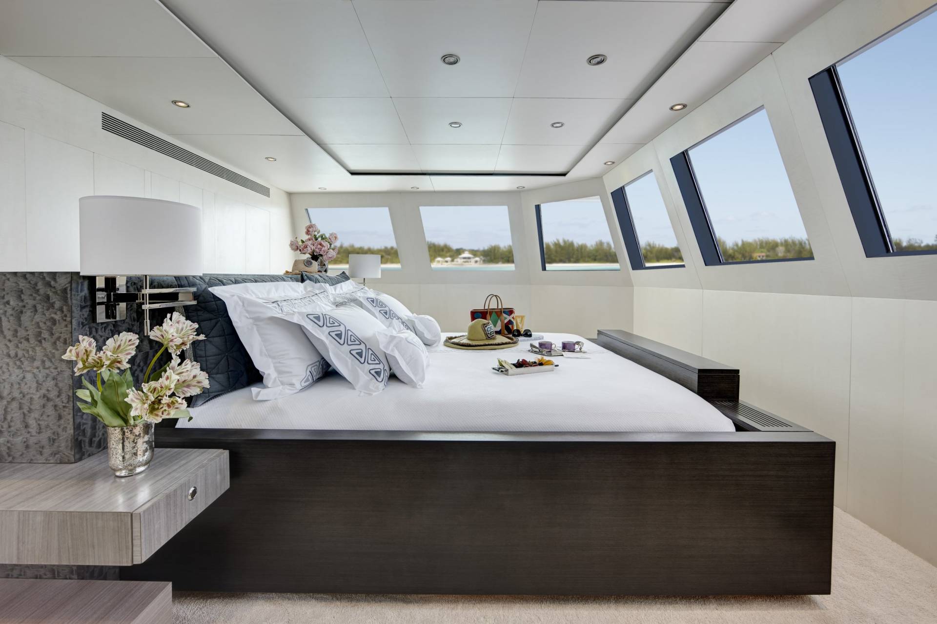 Luxurious yacht cabin offers a serene retreat with stunning ocean views and elegant decor.