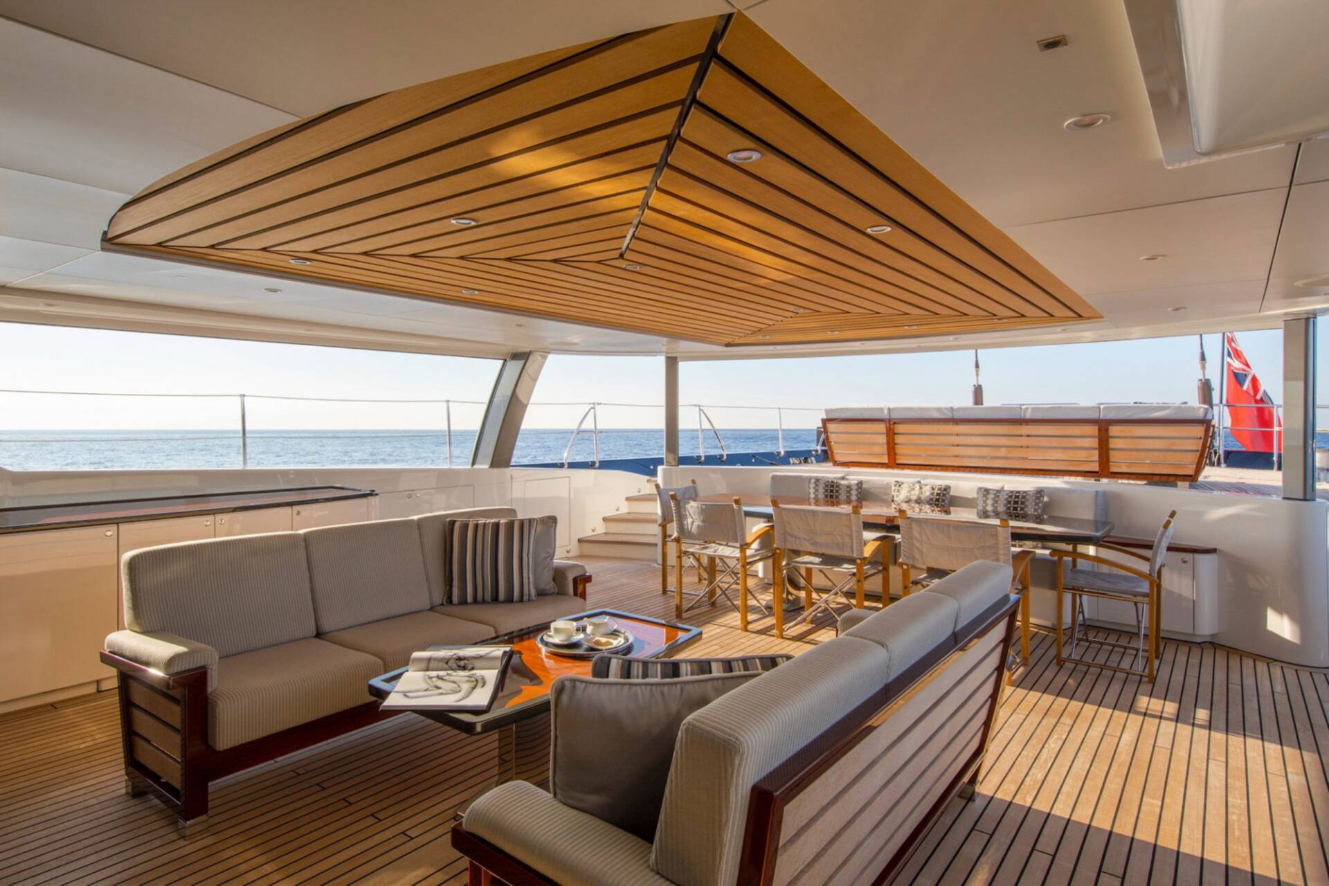 Relax on the spacious deck of this luxury yacht, enjoying the ocean breeze and elegant outdoor seating.