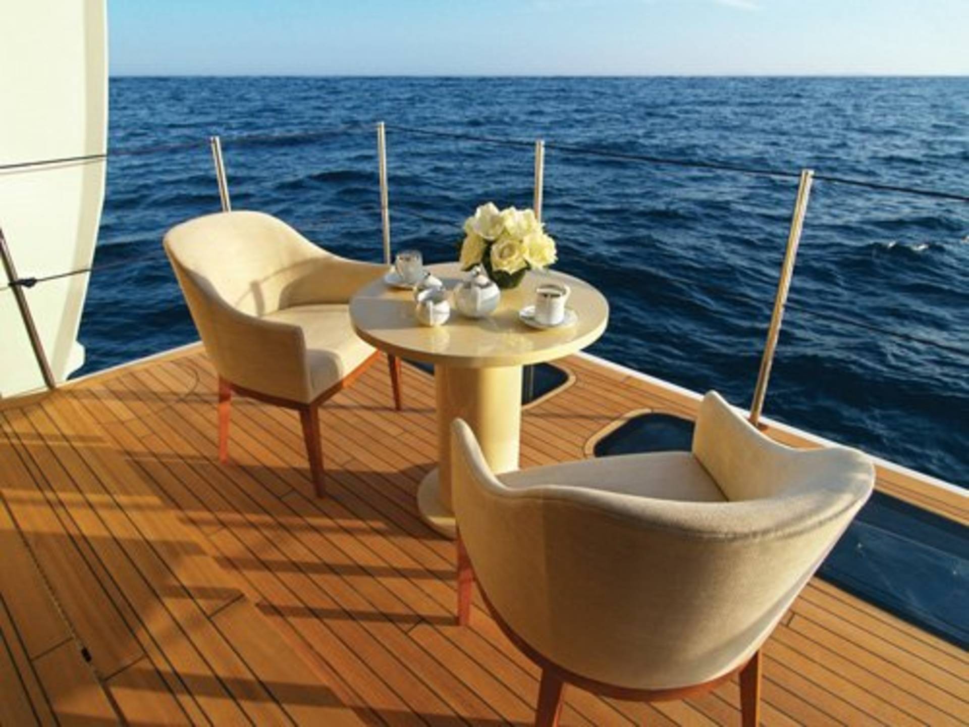 Enjoy a serene morning coffee on deck, surrounded by the endless blue of the ocean.