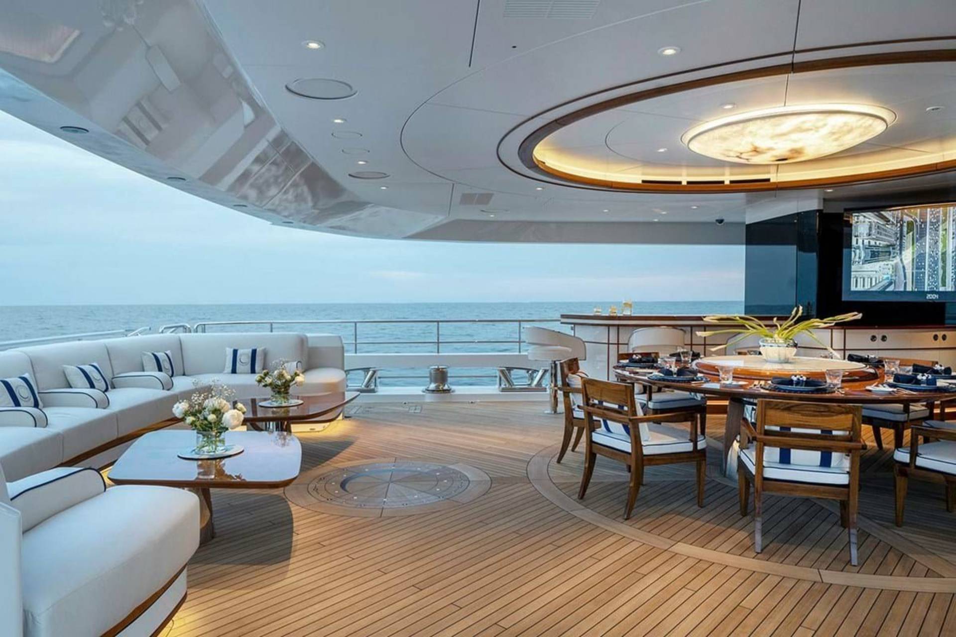 Luxurious yacht deck seating and dining areas offer an elegant space for enjoying the ocean breeze and stunning sea views.
