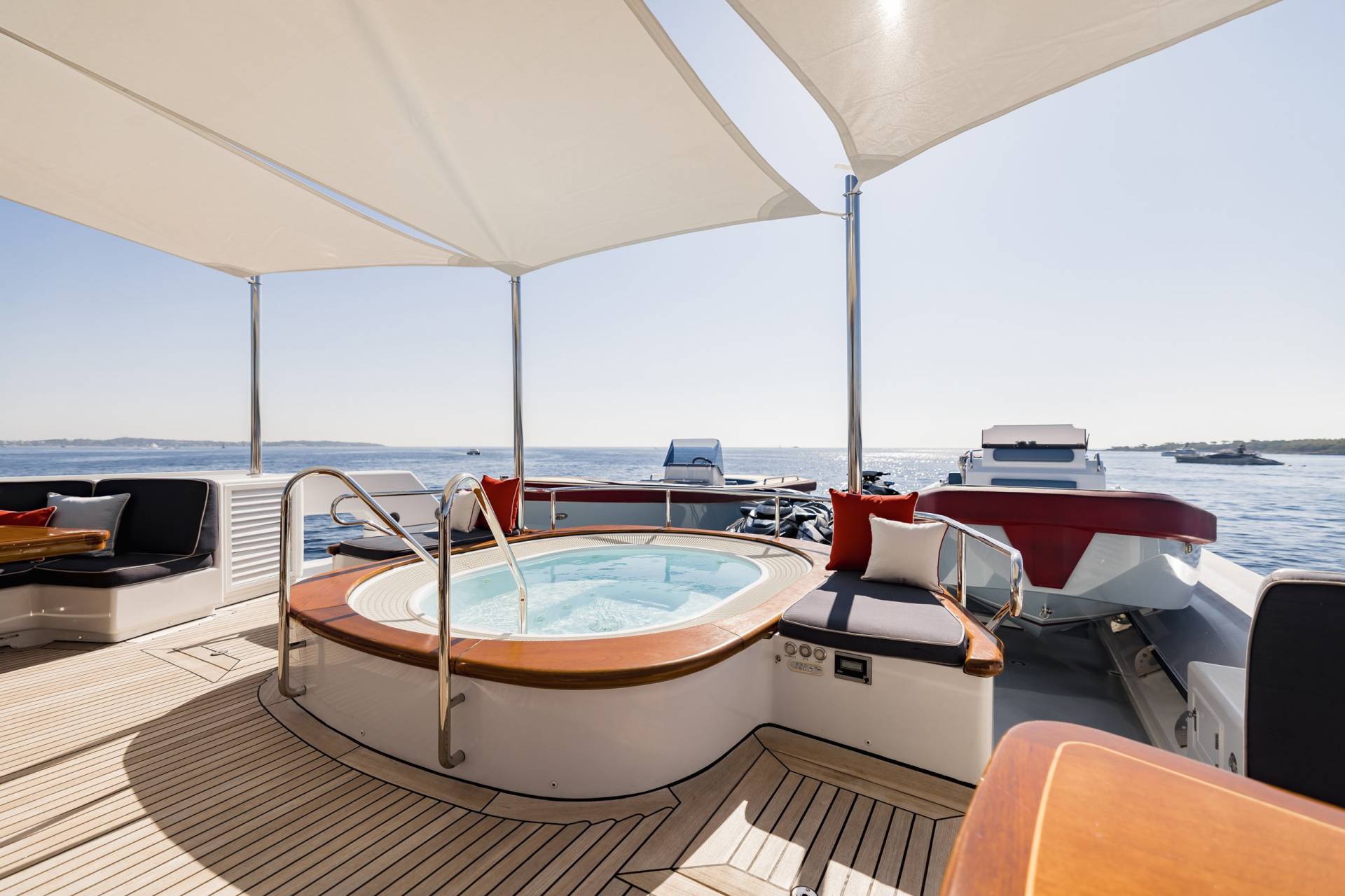 Relax in the onboard jacuzzi while enjoying the stunning ocean views from this luxurious yacht deck.