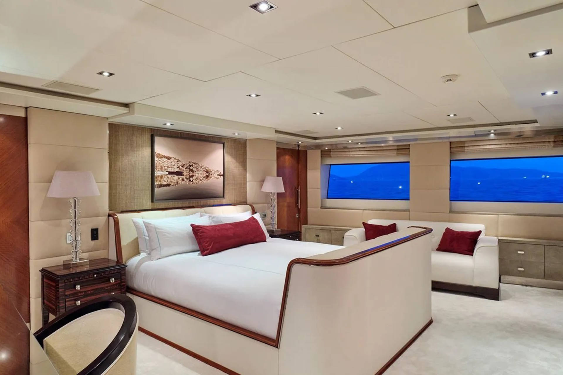 Luxurious yacht stateroom offers a serene retreat with stunning ocean views and plush furnishings.
