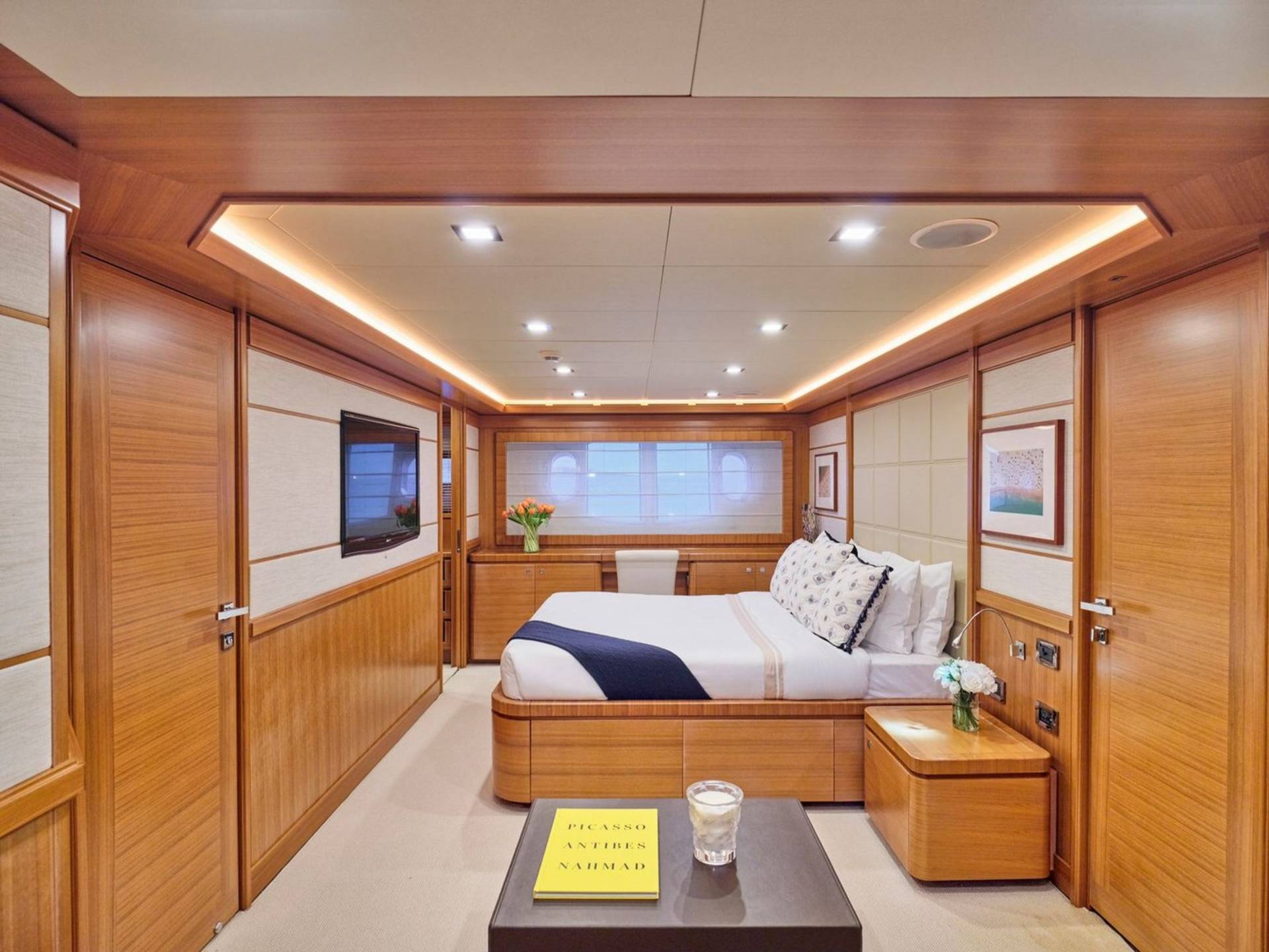 Luxurious wood paneling and soft lighting create a serene and elegant bedroom aboard this yacht.