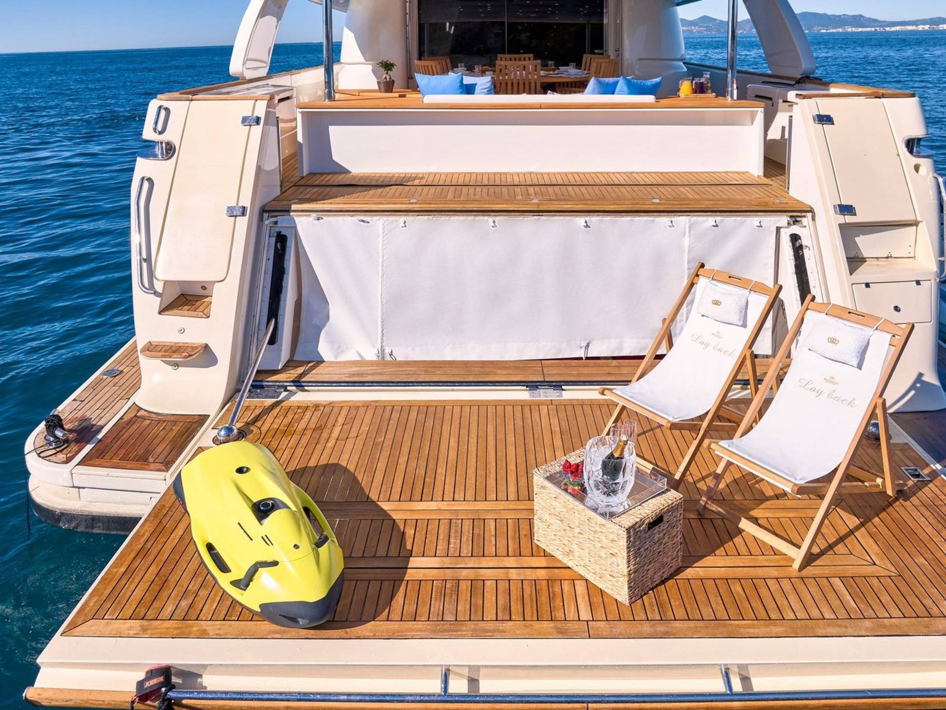 Relax in style on the deck of this luxurious yacht with a chilled bottle of champagne and two comfortable loungers.