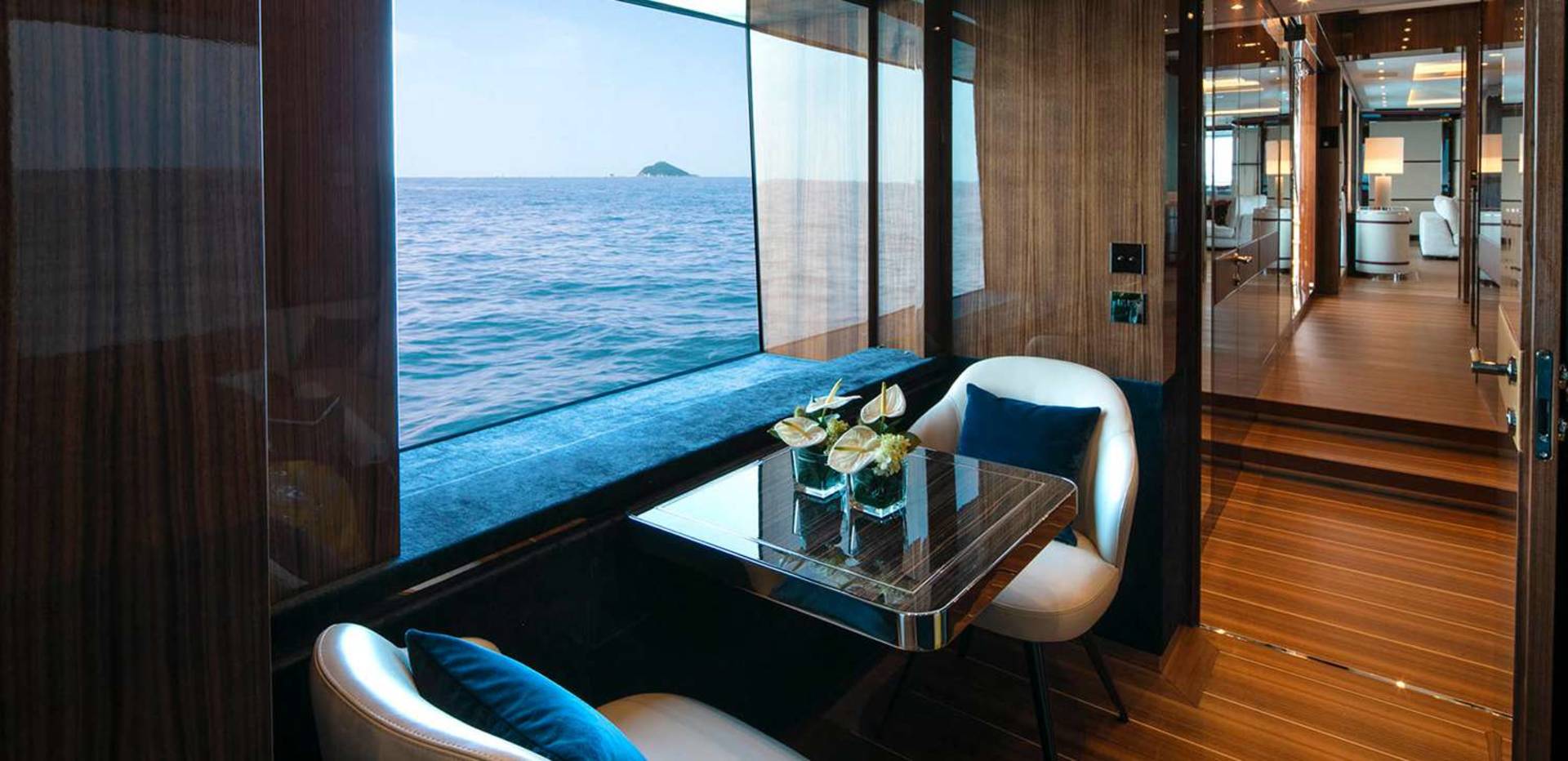 Luxurious yacht interiors offer stunning ocean views from intimate seating areas.