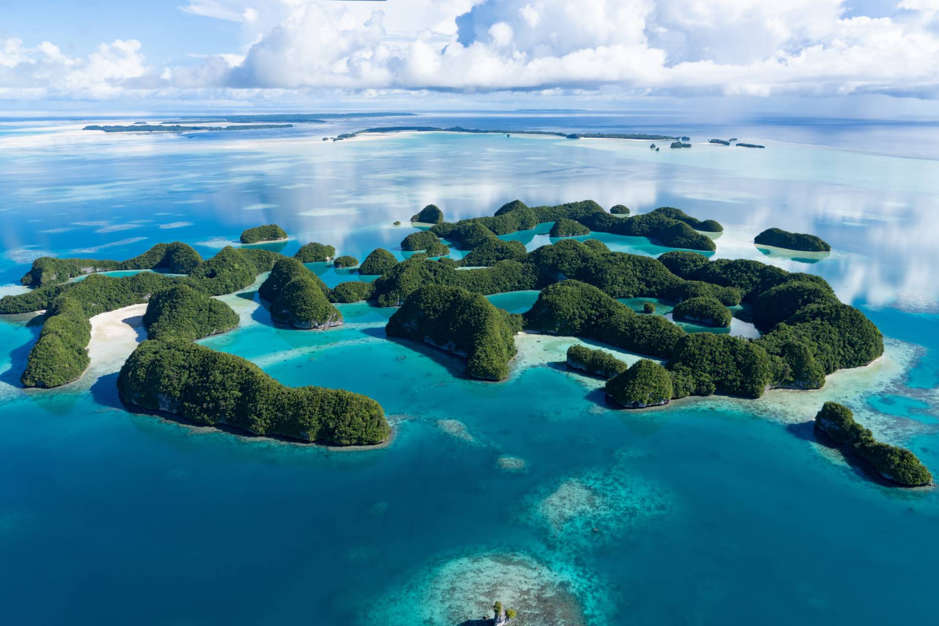 Lush green islands dot the impossibly blue waters of this tropical paradise.