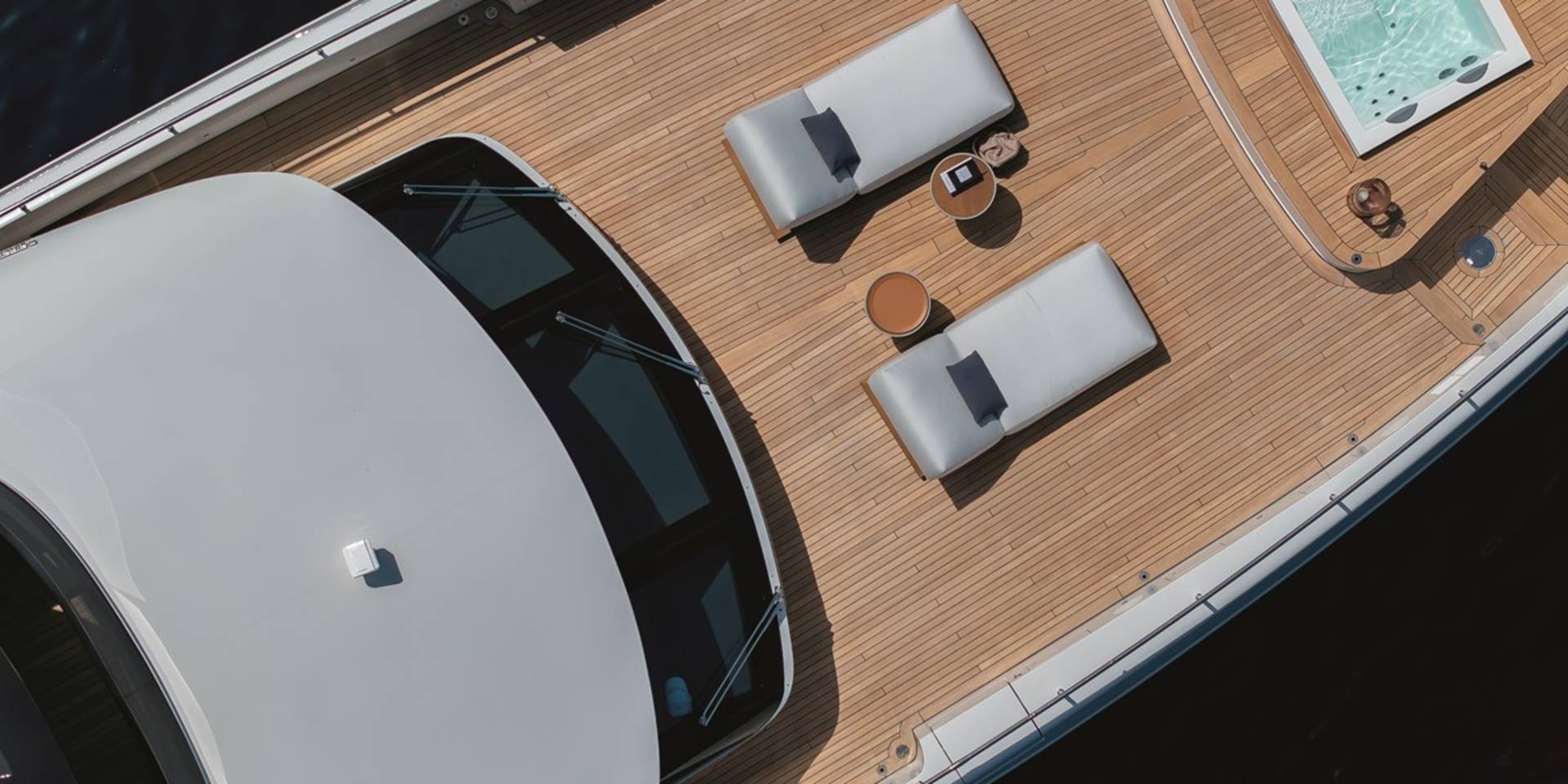 Relax on the sun-drenched deck of this luxurious yacht, complete with comfortable loungers and a refreshing hot tub.