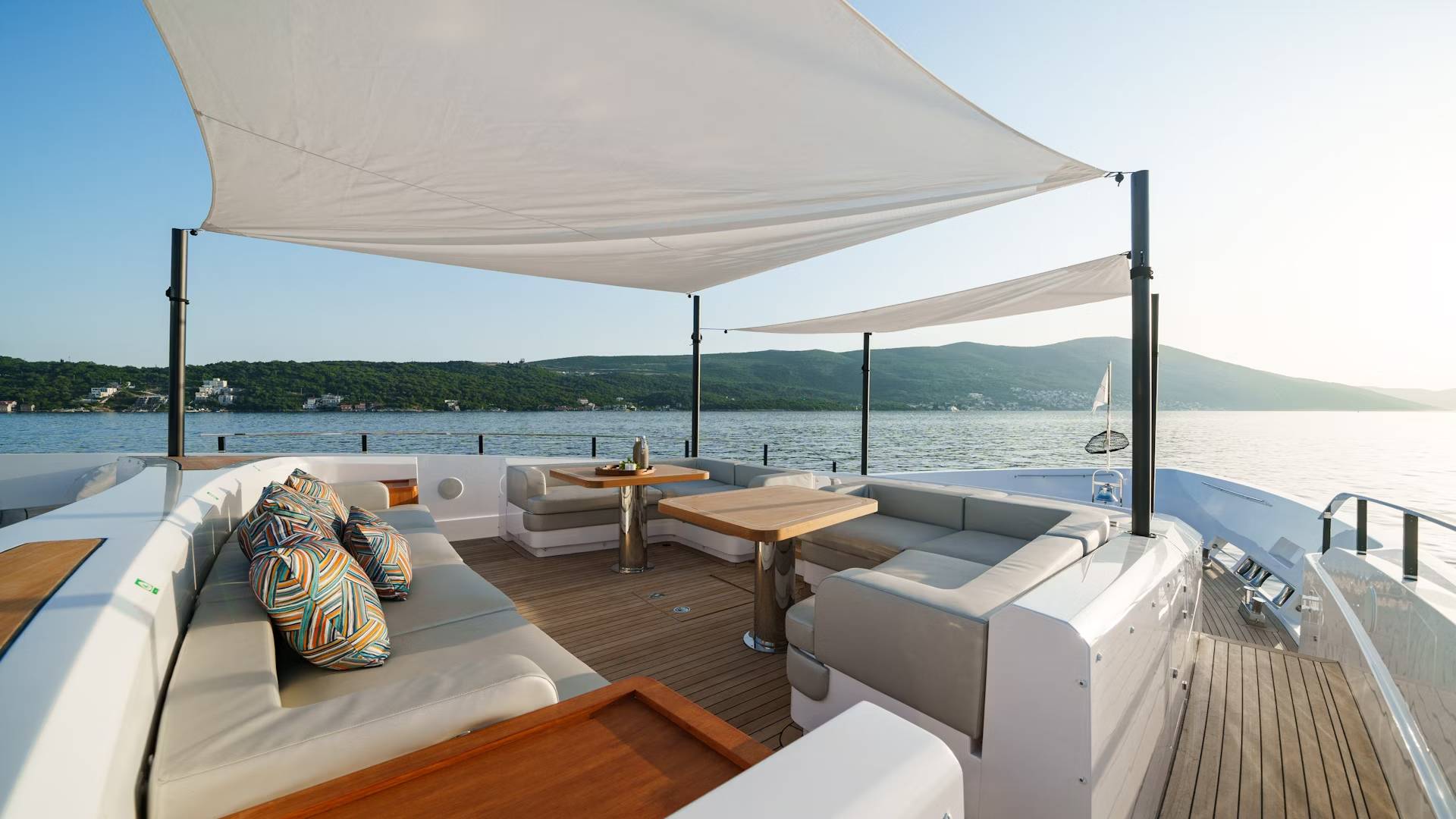 Luxurious yacht seating and dining areas offer a perfect spot to enjoy the serene coastal views.