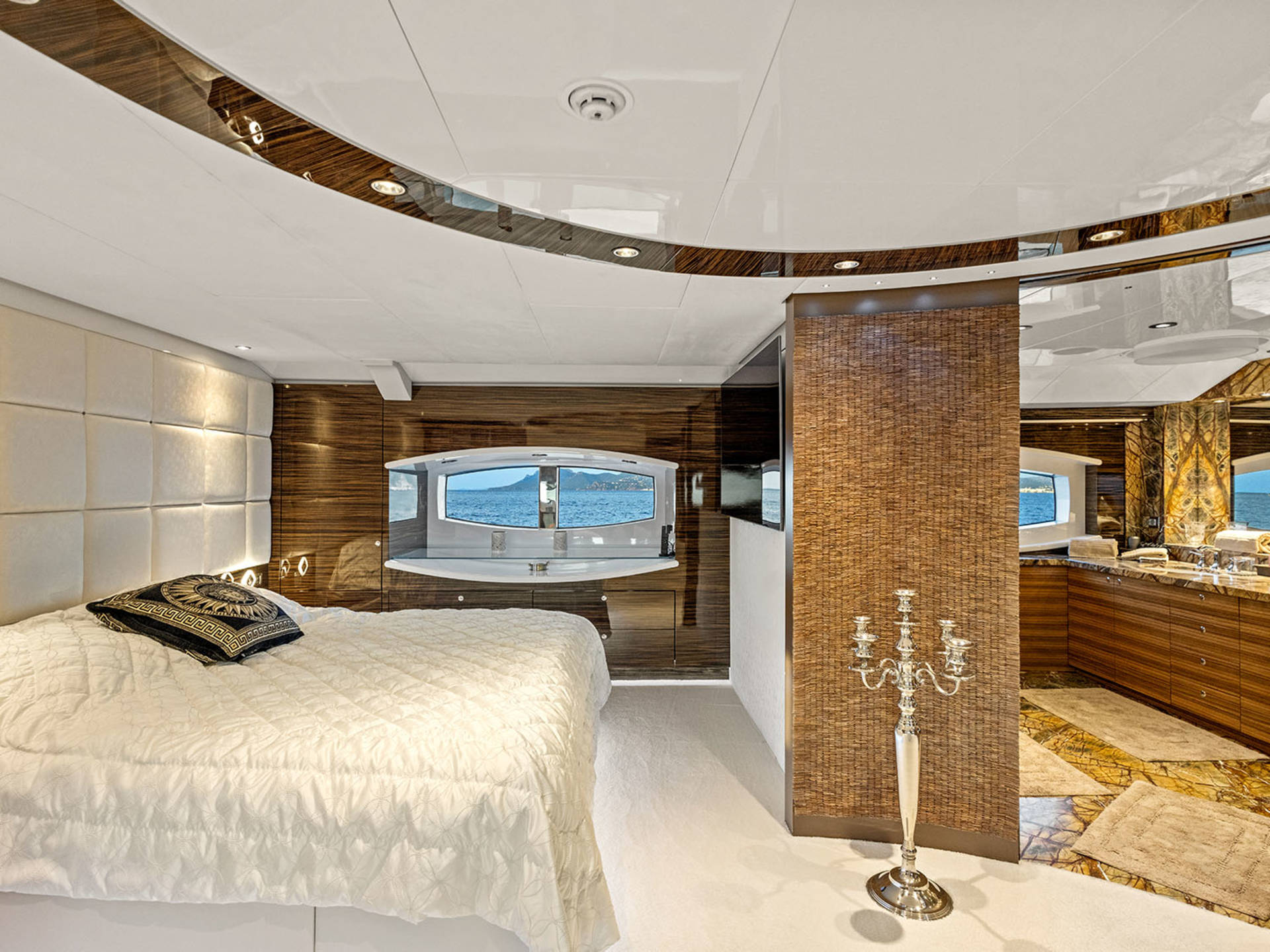 Luxurious yacht interiors offer stunning ocean views from plush bedrooms and elegant bathrooms.