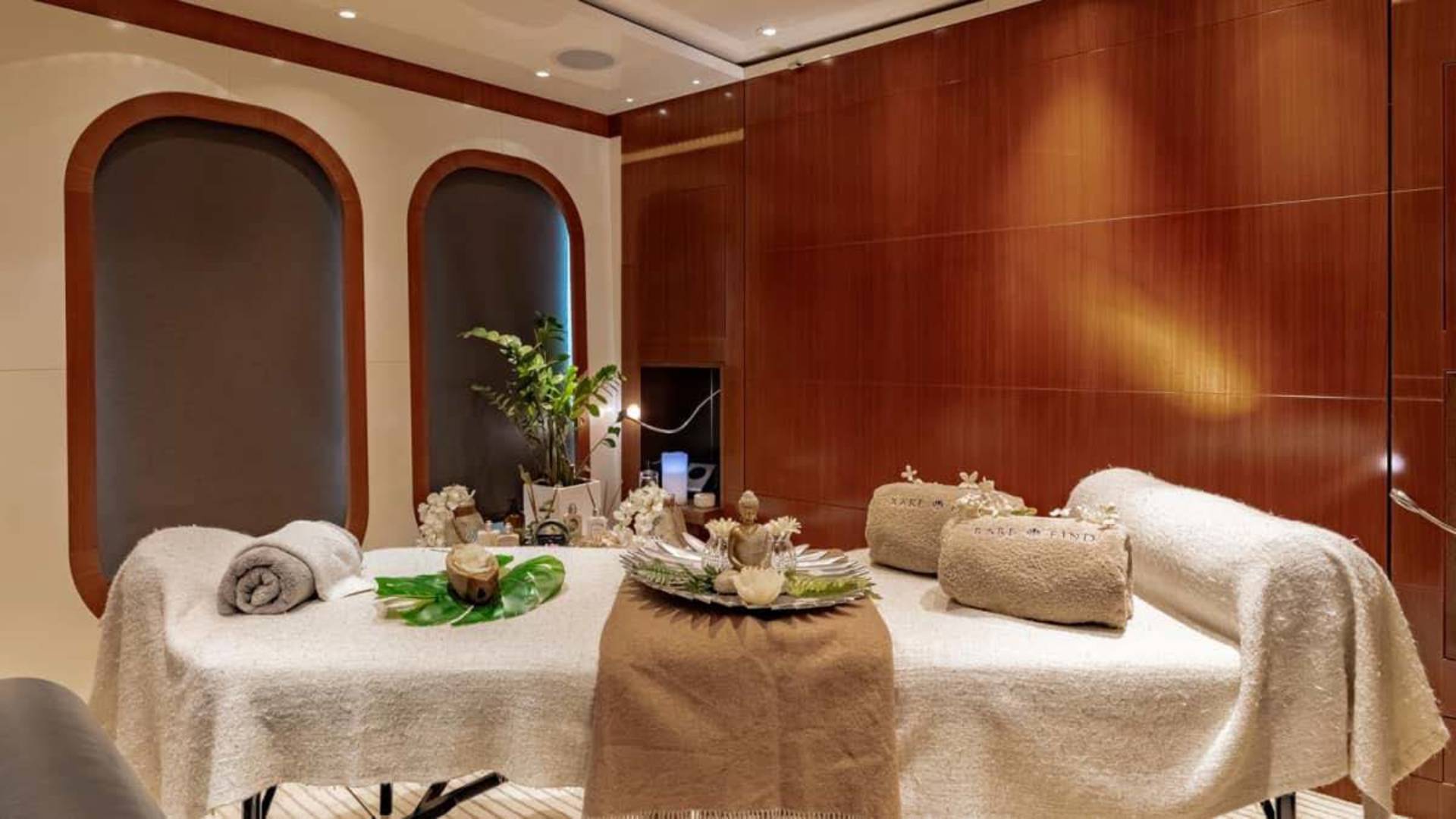 Luxurious spa treatments await in this serene room featuring plush towels and calming decor.