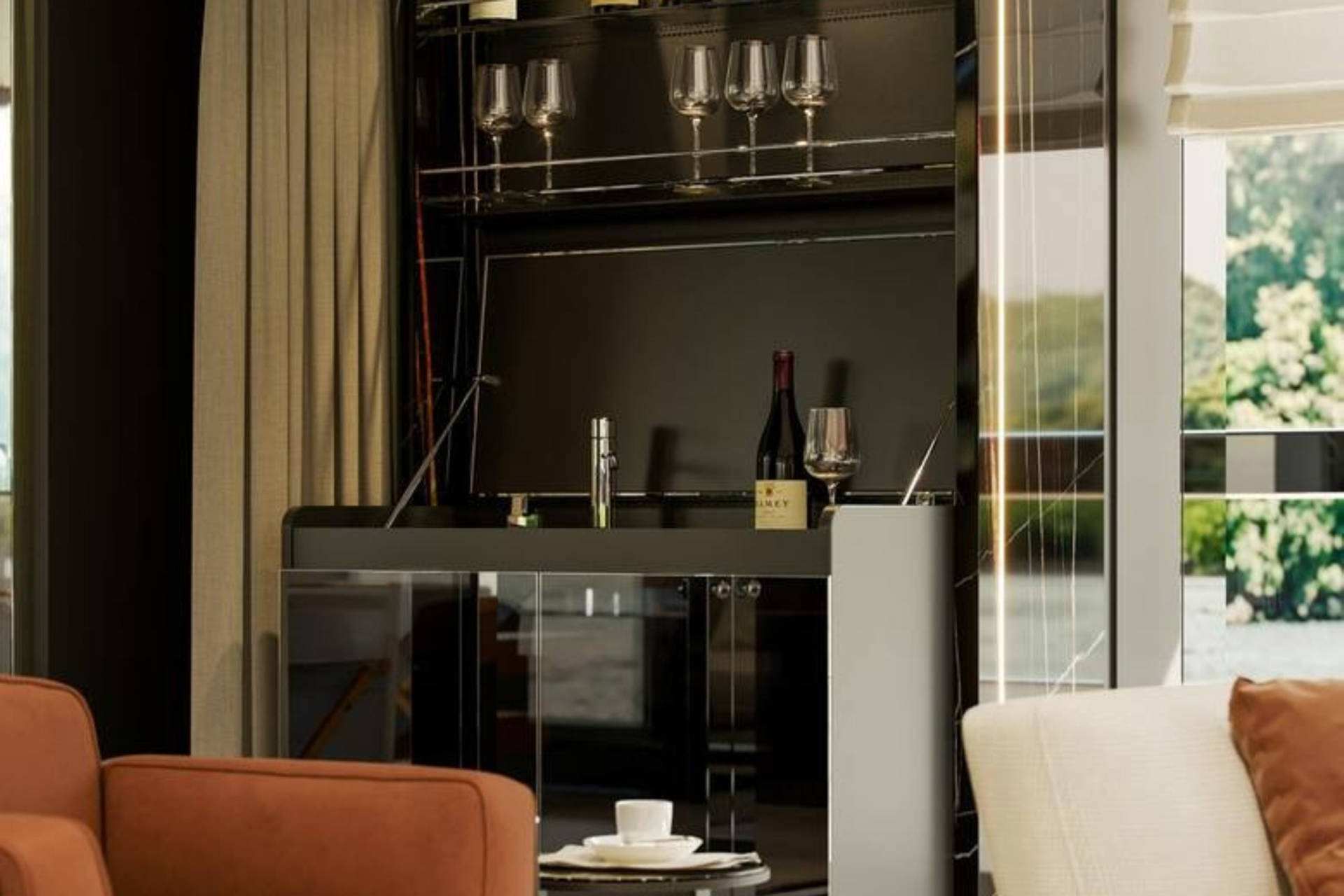 A modern home bar with wine glasses and a bottle of wine is showcased next to a window with a view of lush greenery.