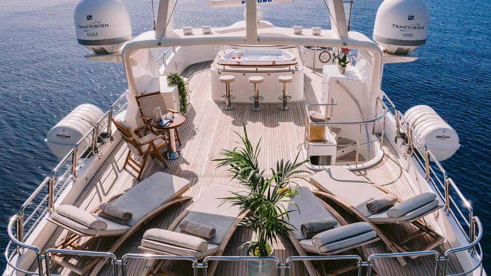 Relax on the spacious deck of this luxurious yacht, complete with a hot tub and comfortable loungers.