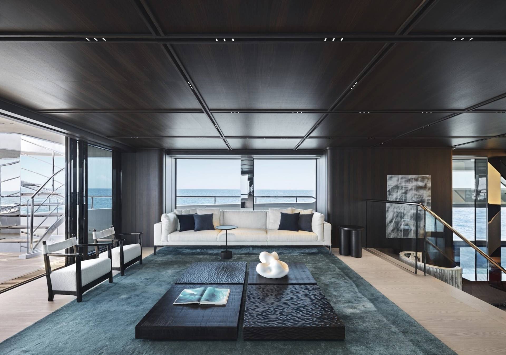 Luxurious yacht interiors offer breathtaking ocean views through expansive windows.