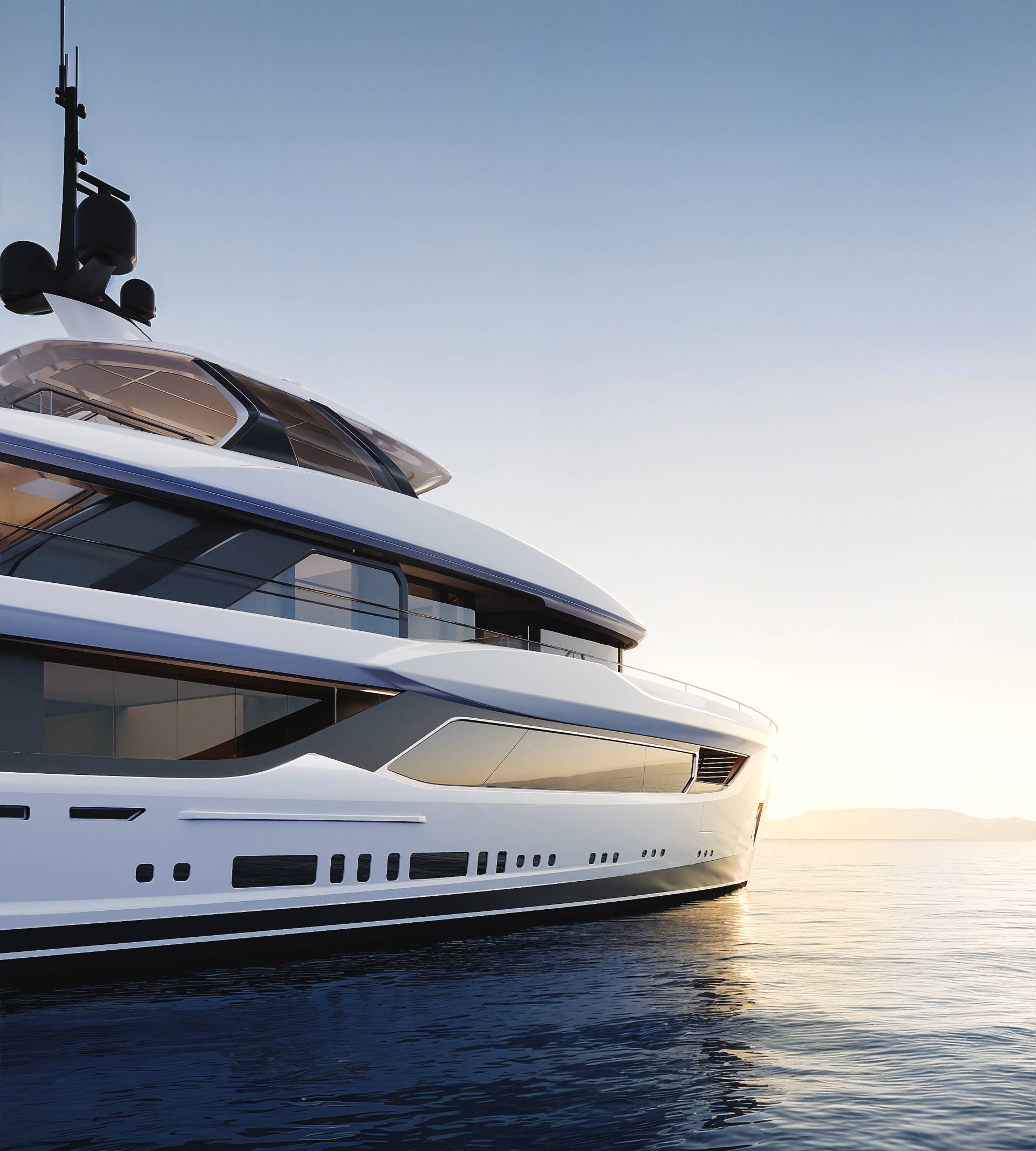 A sleek white luxury yacht floats on calm blue water against a clear sky at sunset.