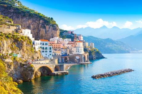 The colorful village of Atrani clings to the cliffs overlooking the azure waters of the Amalfi Coast.