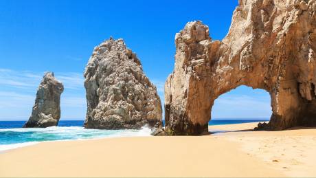 Waves crash against the iconic rock formations of El Arco at Land's End in Cabo San Lucas.