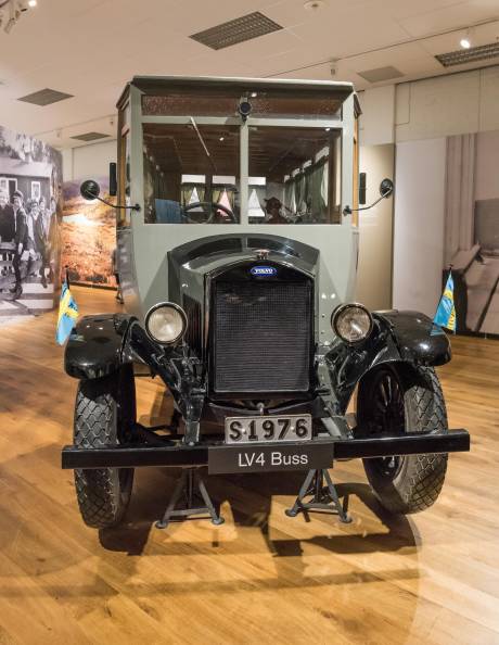 This vintage Volvo LV4 bus, displayed on a polished wooden floor, evokes a bygone era of travel.
