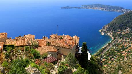 The picturesque village of Eze perches dramatically on a cliff overlooking the stunning blue waters of the French Riviera.