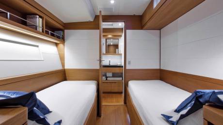 Twin beds and a compact en-suite bathroom offer comfortable accommodations on this luxurious yacht.