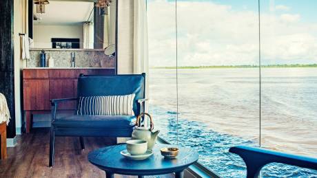 Sip tea by the window while watching the river flow by from your luxurious cabin.