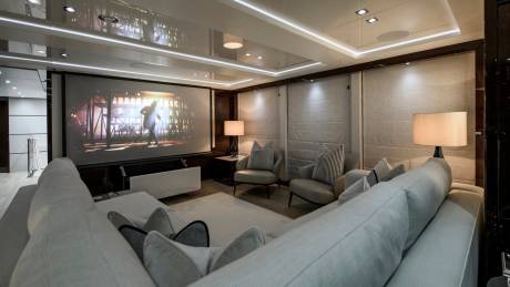 Relax in this luxurious yacht cinema, complete with a large screen and plush seating.