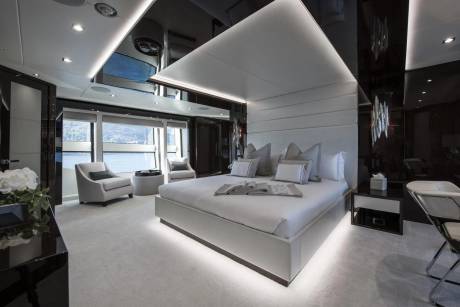 Luxurious yacht master suite offers a serene sanctuary with plush bedding and panoramic ocean views.