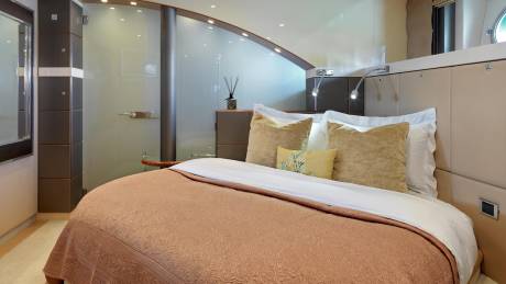 Luxurious bedding and elegant design create a serene retreat within this modern yacht cabin.