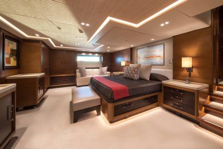 Luxurious wood paneling and soft lighting create a serene ambiance in this opulent yacht bedroom.