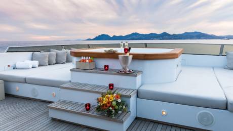Champagne and flowers set the mood for a romantic evening on this luxurious yacht deck.