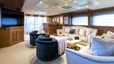 Luxurious yacht interiors feature plush seating, elegant wood paneling, and panoramic windows for a sophisticated onboard experience.