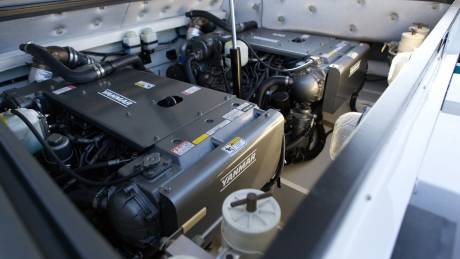 Twin Yanmar engines power this vessel, showcasing robust marine engineering within its clean, organized engine bay.