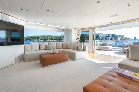 Luxurious yacht interiors seamlessly blend with breathtaking coastal views, offering an unparalleled experience of relaxation and elegance.