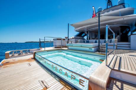 A luxurious yacht features a stunning infinity pool with the name "Northern Escape" etched into its side.