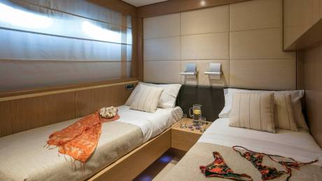 Luxurious twin beds with soft linens and decorative pillows await in this serene cabin.