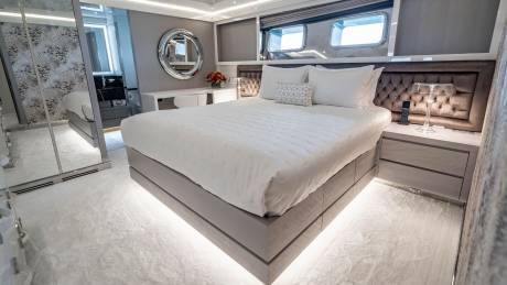 Luxurious yacht interiors feature plush bedding, elegant mirrors, and ambient lighting for ultimate comfort.