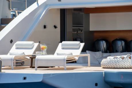 Relax on the deck of this luxurious yacht with comfortable loungers and a refreshing pitcher of fruit-infused water.