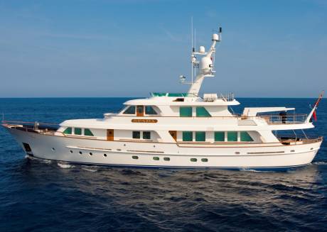 The elegant yacht SPADA glides through the deep blue ocean under a clear sky.